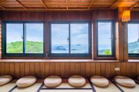 a room with a row of windows with seats at H&amp; Jiufen The Dragon Inn in Jiufen