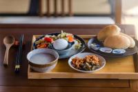 a table with plates of food on a wooden tray at H&amp; Jiufen The Dragon Inn in Jiufen
