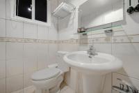 a white bathroom with a toilet and a sink at H&amp; Jiufen The Dragon Inn in Jiufen