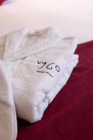 a white towel sitting on top of a bed at Boutique Hotel OLOM - Only Adults recommended in Cádiz