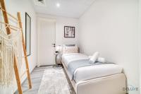 Postel nebo postele na pokoji v ubytování Suave 2BR with Assistant Room at Mesk 1 Midtown Dubai Production City by Deluxe Holiday Homes