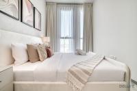 Postel nebo postele na pokoji v ubytování Suave 2BR with Assistant Room at Mesk 1 Midtown Dubai Production City by Deluxe Holiday Homes