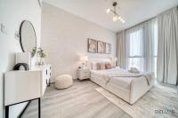 Postel nebo postele na pokoji v ubytování Suave 2BR with Assistant Room at Mesk 1 Midtown Dubai Production City by Deluxe Holiday Homes