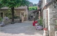 a stone building with flowers on the side of it at Stunning Home In Terrasspn-lavilledieu With 3 Bedrooms, Wifi And Outdoor Swimming Pool in Bouillac