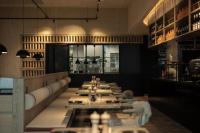 a row of tables in a dining room with lights at the breeze in Ahlbeck