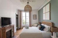 a bedroom with a large bed and a television at Le Goya - Appartement 4 chambres centre ville de Rennes in Rennes