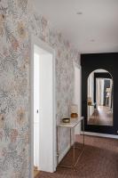 a hallway with a table and a mirror at Le Goya - Appartement 4 chambres centre ville de Rennes in Rennes