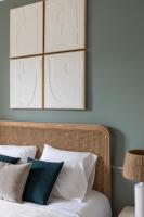 a bed with white pillows and a picture on the wall at Le Goya - Appartement 4 chambres centre ville de Rennes in Rennes