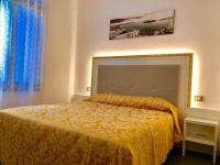 a bedroom with a bed with a yellow bedspread at Hotel Marte in Venice