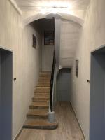 a hallway with a staircase in a building at Appartement rez de chaussée Gold beach in Bayeux