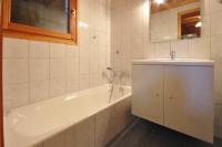 a bathroom with a white tub and a sink at Chalet Le Lapye in Les Gets