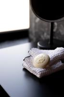 a white soap sitting on top of a towel at Boutique Hotel OLOM - Only Adults recommended in Cádiz