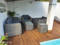 a patio with couches and chairs on a deck at Lavocette maison appartement in Le Grau-dʼAgde