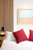 a bedroom with a bed with red pillows at Boutique Hotel OLOM - Only Adults recommended in Cádiz