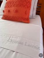 a red pillow sitting on top of a bed at Villa Libellule in Grand-Bourg