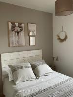 a bedroom with a white bed with two pillows at Le calme de la campagne proche de tout..... in Les Arcs sur Argens