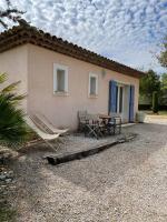 a house with a table and chairs in front of it at Le calme de la campagne proche de tout..... in Les Arcs sur Argens