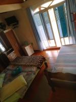 a bedroom with two beds in a room with windows at Pousada Colina Da Neve in São Joaquim