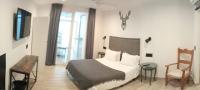 A bed or beds in a room at La Posada del Teatro H Boutique Parking Gratis
