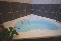 a white bath tub with red sprinkles in it at Green Window Homestay in Hualien City