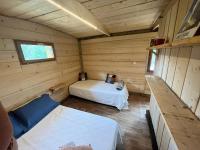 Una cama o camas en una habitaci&oacute;n de La Cabane de Mercone MELU