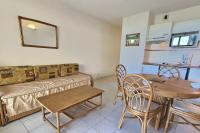 a living room with a couch and a table and chairs at A 50m de la plage, appartement pour 6 personnes avec terrasse in Valras-Plage