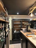a bar with a counter with bottles and glasses at Chambres d'hôtes Nuits Campagnardes in Campagne-lès-Hesdin