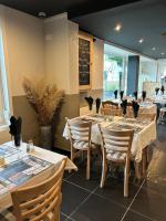 a dining room with tables and chairs and a chalkboard at Chambres d'hôtes Nuits Campagnardes in Campagne-lès-Hesdin