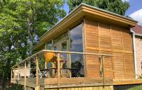 a tiny house with a large sliding glass door at The Lodge in Bilzen