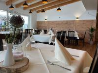 a dining room with white tables and chairs at Hotel Gaststätte Weinbrücke in Kulmbach