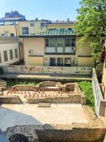 a building with a garden in front of it at BAJKA in Čačak