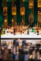a shelf filled with lots of bottles of alcohol at Paris Hotel Yerevan in Yerevan