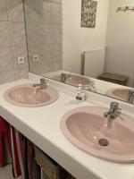 a bathroom with two sinks and a large mirror at Appart Hypercentre Biarritz - PKG &#47; WIFI &#47; 4-6 Personnes in Biarritz