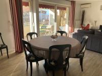 a dining room table and chairs in a living room at Appart Hypercentre Biarritz - PKG &#47; WIFI &#47; 4-6 Personnes in Biarritz