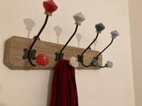 a wooden coat rack with lights on a wall at Appart Hypercentre Biarritz - PKG &#47; WIFI &#47; 4-6 Personnes in Biarritz