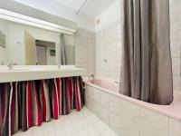 a bathroom with a sink and a tub and a mirror at Appart Hypercentre Biarritz - PKG &#47; WIFI &#47; 4-6 Personnes in Biarritz