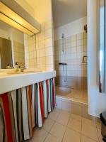 a bathroom with a shower and a sink and a tub at Appart Hypercentre Biarritz - PKG &#47; WIFI &#47; 4-6 Personnes in Biarritz