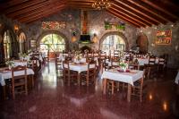 a dining room with tables and chairs and stained glass windows at Hotel Tiosh Abaj in Santiago Atitlán