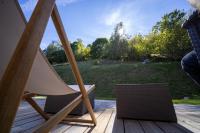 a chair on a deck with a view of a field at Le 11 des Bouchaux, Gîte d&#39;exception in La Bresse