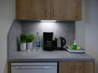 a kitchen counter with a coffee maker and plants at Pension Maiglöckchen in Karlshagen