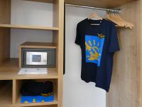 a room with a t shirt and a tv at Pension Maiglöckchen in Karlshagen