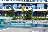 a swimming pool in front of a building at Sheraton Dubrovnik Riviera Hotel in Mlini