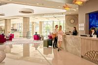 a lobby with people standing at a counter at Sheraton Dubrovnik Riviera Hotel in Mlini