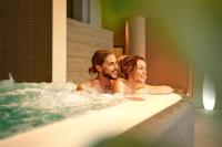 a man and woman sitting in a bathtub at Sheraton Dubrovnik Riviera Hotel in Mlini