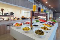a buffet line with bowls of food on a table at Sheraton Dubrovnik Riviera Hotel in Mlini