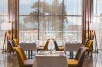 a restaurant with tables and chairs and large windows at Sheraton Dubrovnik Riviera Hotel in Mlini