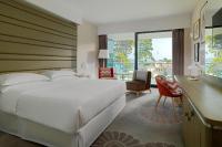 a bedroom with a large white bed and a desk at Sheraton Dubrovnik Riviera Hotel in Mlini