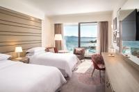 a hotel room with two beds and a large window at Sheraton Dubrovnik Riviera Hotel in Mlini