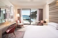 a hotel room with a bed and a desk with a view at Sheraton Dubrovnik Riviera Hotel in Mlini