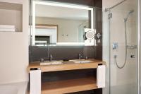 a bathroom with two sinks and a large mirror at Sheraton Dubrovnik Riviera Hotel in Mlini